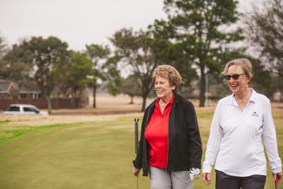 DaVita home dialysis patient Claire enjoys a day of golf with her care partner, Sally.