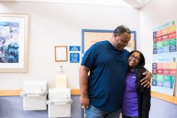 A transplant recipient embraces his DaVita social worker